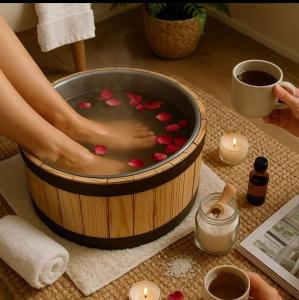 a woman soaking her feet in a hot tub filled with pink hearts at GUARULHOS FLAT CENTER - Apart-Hotel in Guarulhos