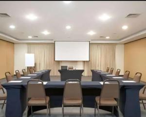 a conference room with a long table and chairs at GUARULHOS FLAT CENTER - Apart-Hotel in Guarulhos +22 photos