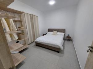 a bedroom with a bed and shelves in it at Villa Le Caprice in Grand-Baie +6 photos
