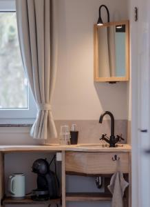 a kitchen counter with a sink and a window at B&B Keukja Cuijk in Cuijk