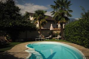a swimming pool in the yard of a house at Jägerheim in Vilpiano
