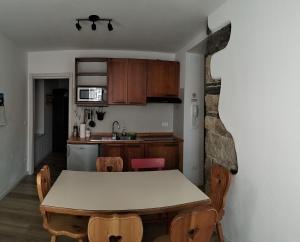 a kitchen with a table and chairs in a room at Casa Nonna Giovanna in Tesero