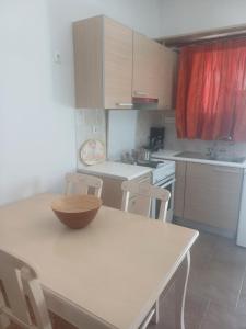 a kitchen with a table with a bowl on it at Korali in Skiros