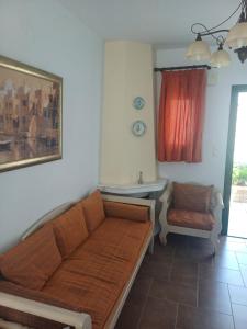 a living room with a couch and a chair at Korali in Skiros