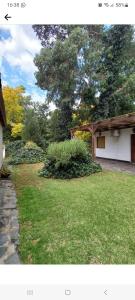 a picture of a yard with a house at Cabañas del Gordo in Mar del Plata