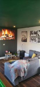 a living room with a couch and a fireplace at Atlantic Coast Lodge in Spanish Point