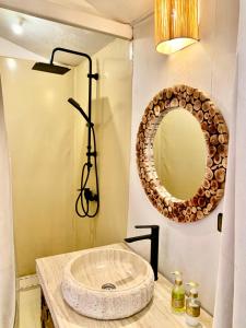 a bathroom with a sink and a mirror at Rosara Luxury Camp in Merzouga +62 photos