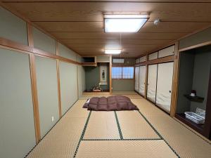 a room with a bed in the middle of it at 民泊 シェアハウス北浦 in Senboku