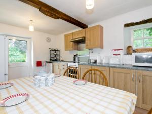 a kitchen with a table with plates on it at The Cottage in Gosforth