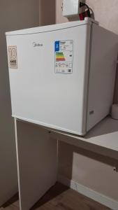a white refrigerator sitting on top of a counter at Casa Janela Azul in Belém