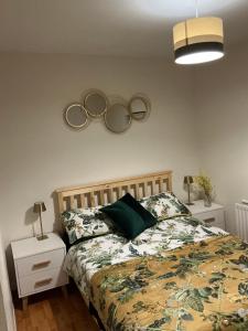 a bedroom with a bed with two olympic mirrors on the wall at Rose Cottage Moira in Moira