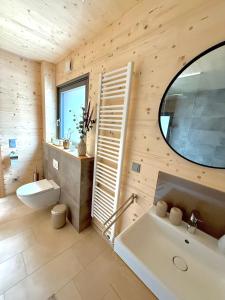a bathroom with a white sink and a mirror at Wohnen am Südhang in Amberg +24 photos