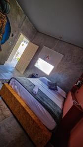 a bedroom with a bed in a room with a window at Urban Hostel Pool & Garden in San Gil
