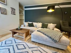 a living room with a couch and a table at Stadtwohnung Hygge Home in Neustadt in Holstein