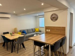 a living room with a table and a couch at Cottage des Lacs in Puttelange-aux-Lacs