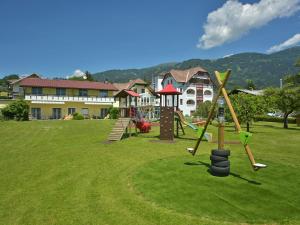a park with a playground with slides and swings at Ferienwohnungen Kampitsch in Seeboden