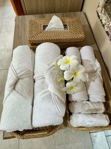 a bunch of towels on a table in a bathroom at Bananaland Cottages in Panglao Island