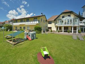a yard with a playground in front of a house at Ferienwohnungen Kampitsch in Seeboden