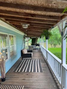 a porch with a swing on a house at 3 bedroom River cabin retreat ! in Terre Haute