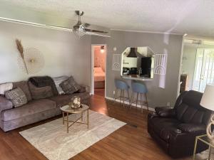 a living room with a couch and a table at 3 bedroom River cabin retreat ! in Terre Haute