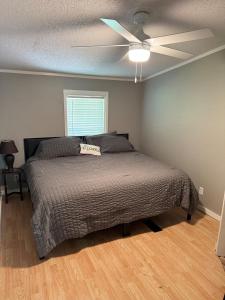 a bedroom with a bed and a ceiling fan at 3 bedroom River cabin retreat ! in Terre Haute