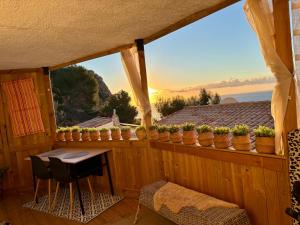 a balcony with a table and a view of the ocean at Casa Halcón in Jávea