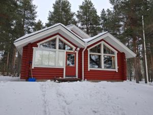 a red tiny house in the snow at Villa Kalkonniemi in Kemijärvi