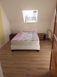 a bedroom with a bed and a window at Pension-Auszeit in Giesen +2 photos