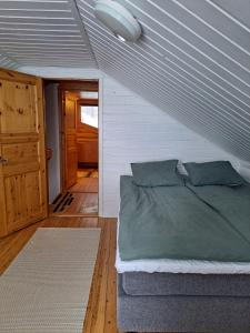 a bedroom with a bed in a room with a door at Villa Kalkonniemi in Kemijärvi
