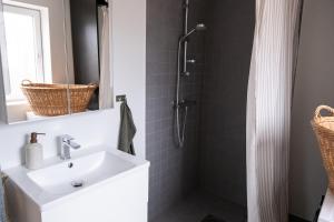 a bathroom with a sink and a shower at Bokskogen stugby hus två in Jönköping