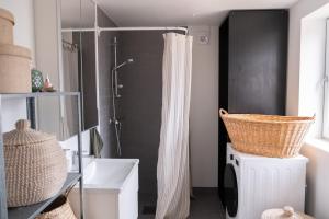 a bathroom with a shower with a shower curtain at Bokskogen stugby hus två in Jönköping