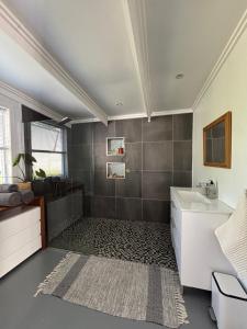 a bathroom with a sink and a bath tub at 1 Fountain private pool in Hout Bay