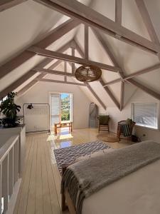a bedroom with a bed and a ceiling with beams at 1 Fountain private pool in Hout Bay