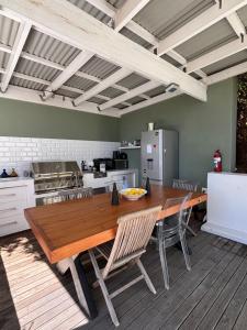 a large kitchen with a wooden table and chairs at 1 Fountain private pool in Hout Bay +16 photos