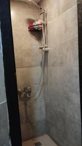 a shower with a hose in a bathroom at Gafa Garden Hostel & Apartments - Great Location in Istanbul