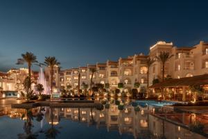 a hotel with a pool in front of a building at Grand Palace - Couples only 18 years plus in Hurghada