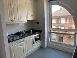 a kitchen with a sink and a window at Apartamento somo SARR in Somo