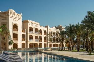 a building with a swimming pool in front of it at Grand Palace - Couples only 18 years plus in Hurghada