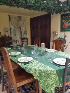a table with plates and glasses on top of it at Le Riolet in Marsac-en-Livradois