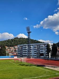 a building with a soccer field in front of it at Leotar View Apartment in Trebinje