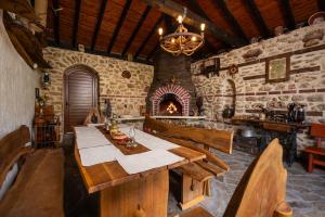 a dining room with a table and a fireplace at Villa Komitata-Pool and Jacuzzi in Balchik