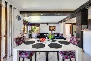 a kitchen and living room with a table and chairs at Villa Komitata-Pool and Jacuzzi in Balchik