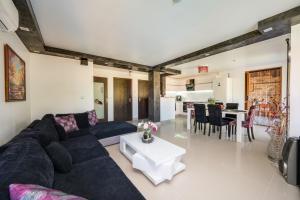 a living room with a couch and a table at Villa Komitata-Pool and Jacuzzi in Balchik