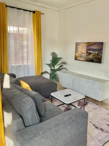 a living room with a couch and a table at Jenka homes in Kitui