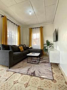 a living room with a couch and a table at Jenka homes in Kitui