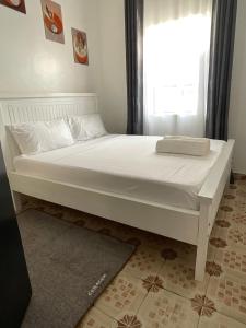 a large white bed in a room with a window at Jenka homes in Kitui +17 photos