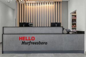 a reception desk with a hellomindbersroom sign in a lobby at TownePlace Suites by Marriott Murfreesboro in Murfreesboro +30 photos