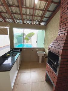 a bathroom with a sink and a toilet in it at Casa de lazer 3Y in Maringá