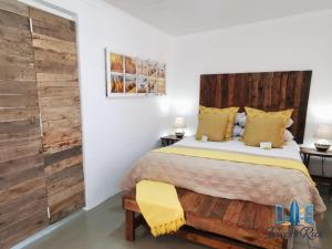 a bedroom with a bed and a wooden wall at Iewers Rus in Strand