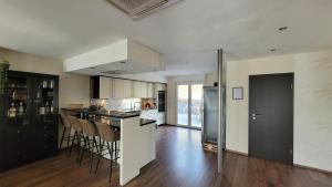 a kitchen with a counter and chairs in a room at Moselanker de in Enkirch Mosel in Enkirch